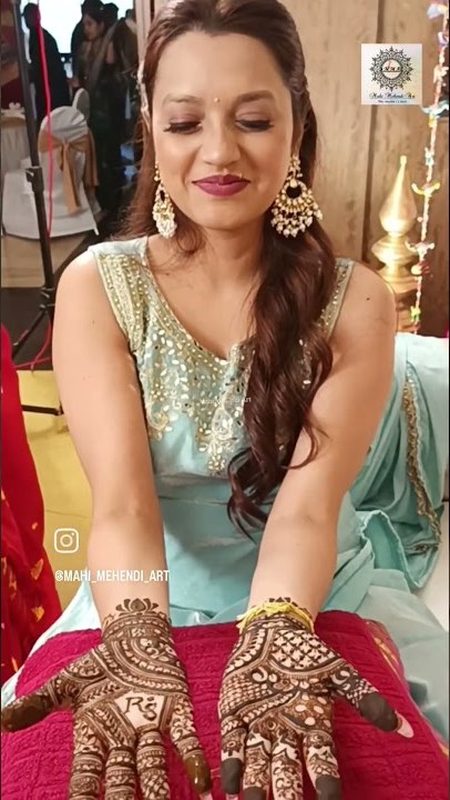 Bride showing bridal mehendi by Mahi Mehendi Art